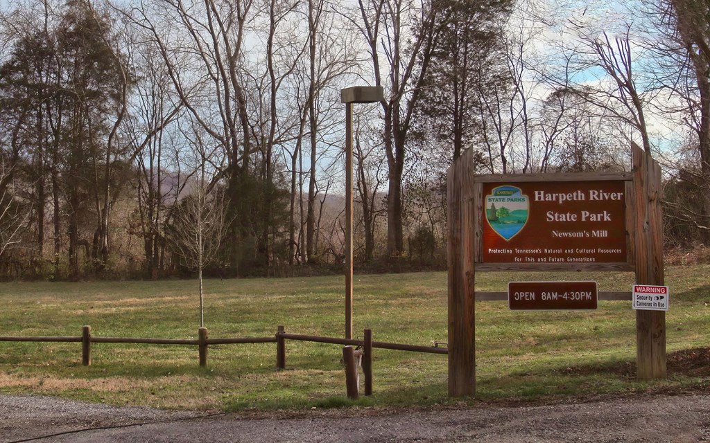 Entrance to Harpeth River State Park with Scenic Tree Line and Signage