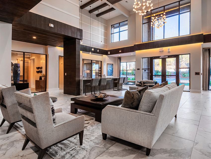 a large living room with a couch and chairs