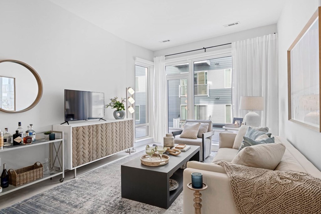 A modern living room with a large window and a flat screen TV.