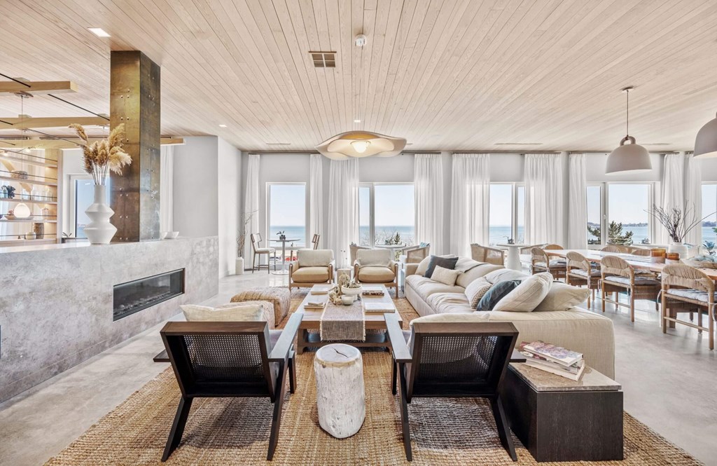 A modern living room with a fireplace and a large window.