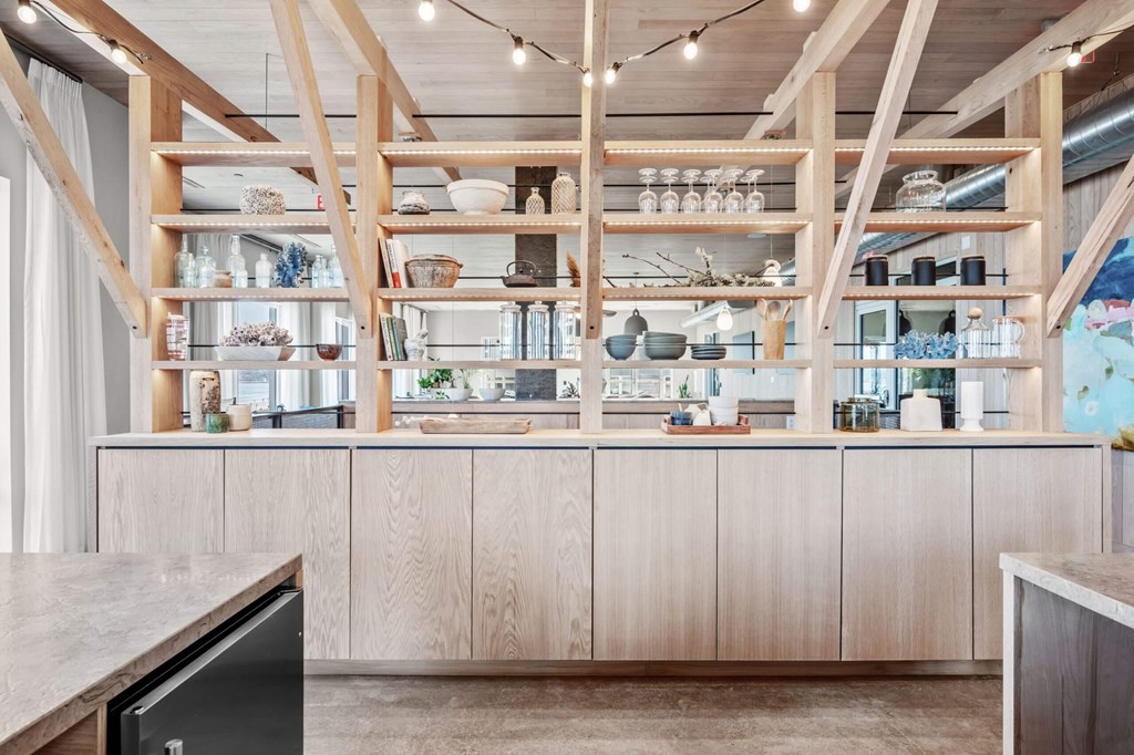 A kitchen with wooden shelves and cabinets.