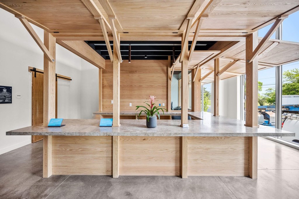 A wooden table with a plant on it in a room with wooden beams.