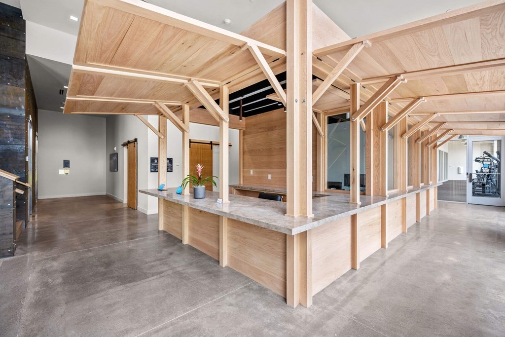 A large open space with a wooden beam ceiling and concrete flooring.