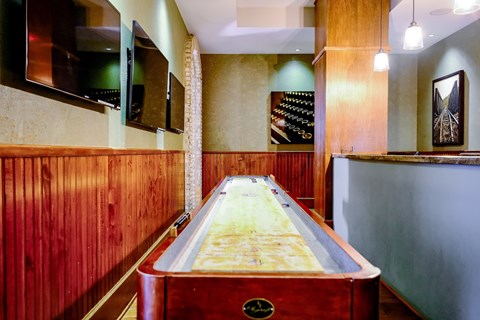 A pool table in a room with wooden walls.