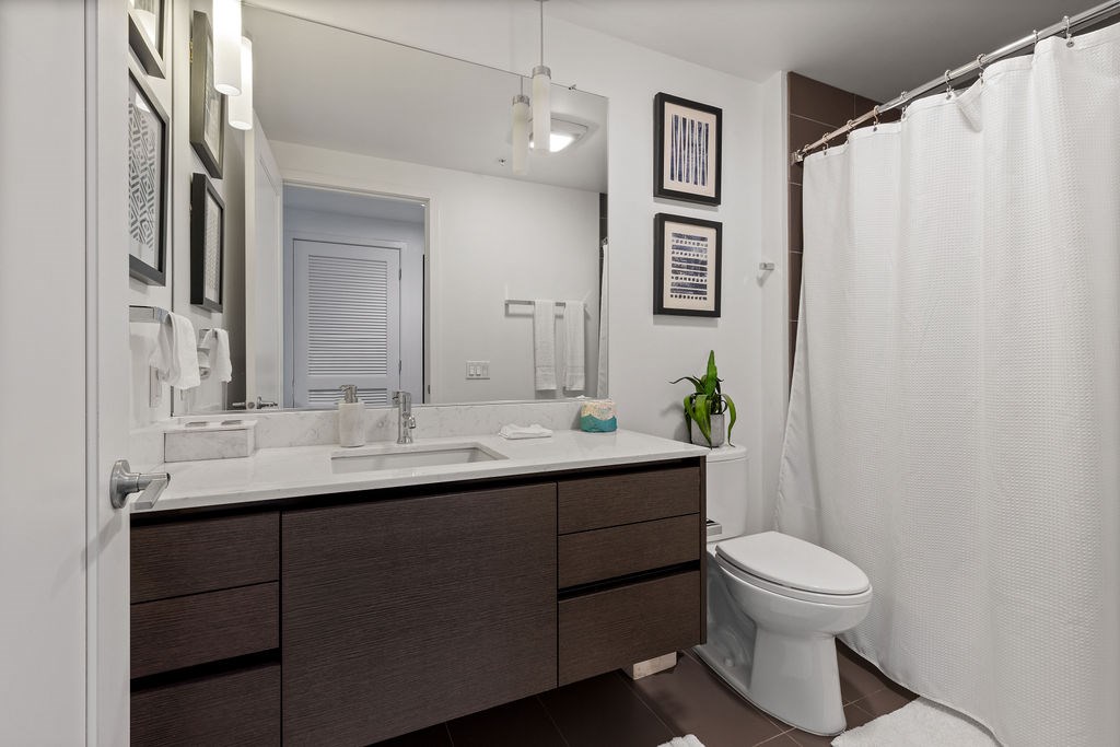 A white toilet sits next to a sink in a bathroom.
