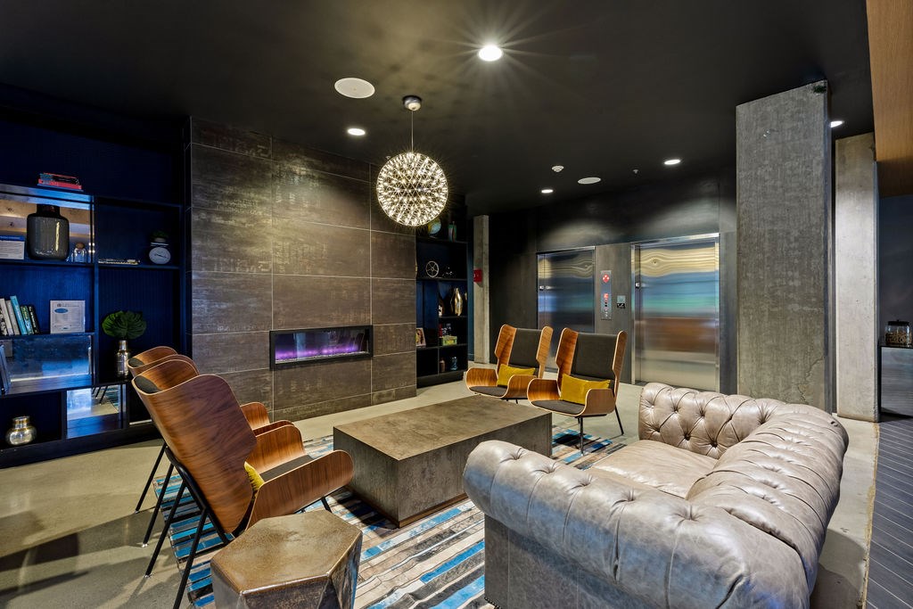 A modern living room with a fireplace and a large couch.