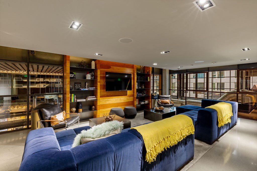 A living room with a blue couch and a yellow throw blanket.