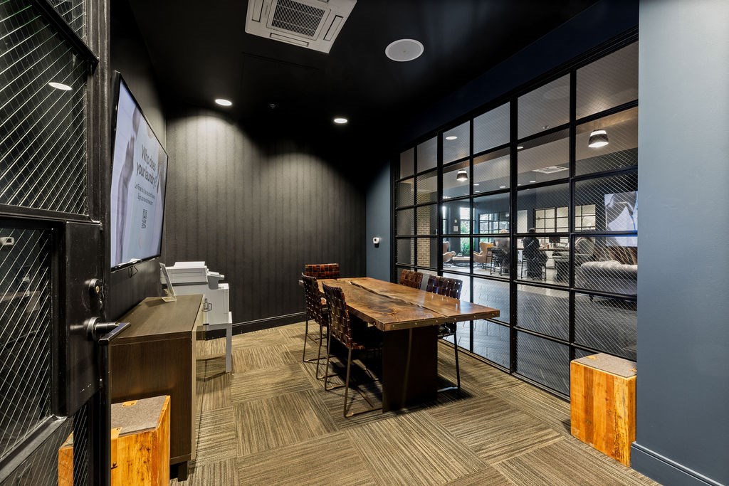 A conference room with a long table and chairs.