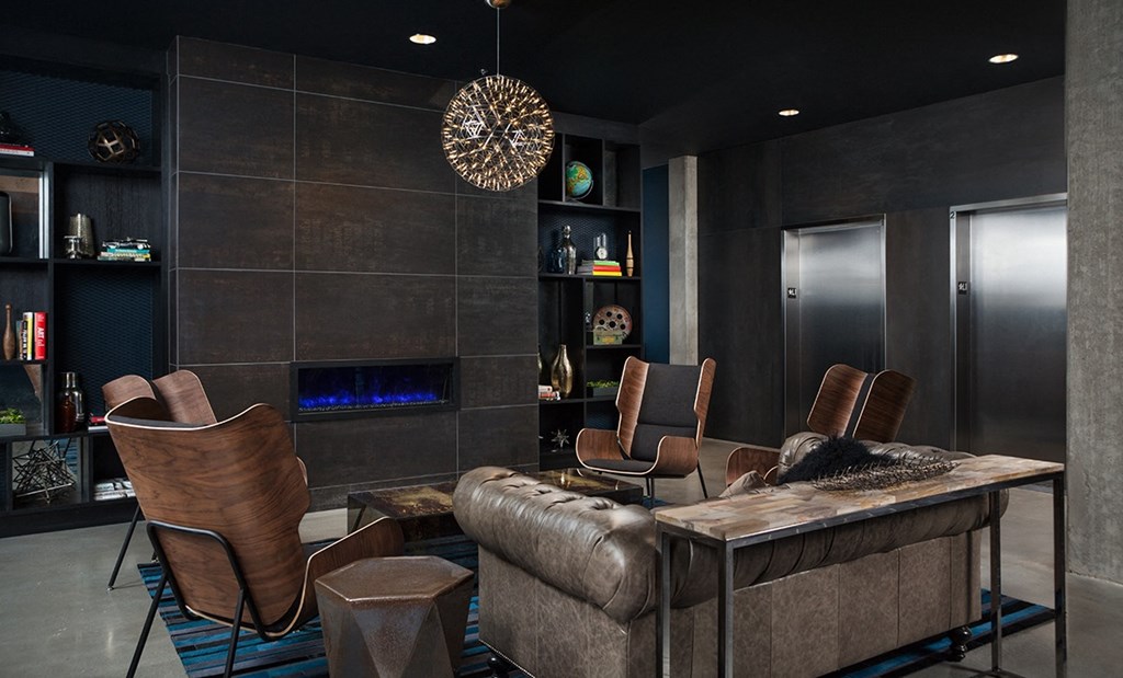 Stylish Resident Lounge with Leather Seating and Modern Fireplace at Pike Motorworks