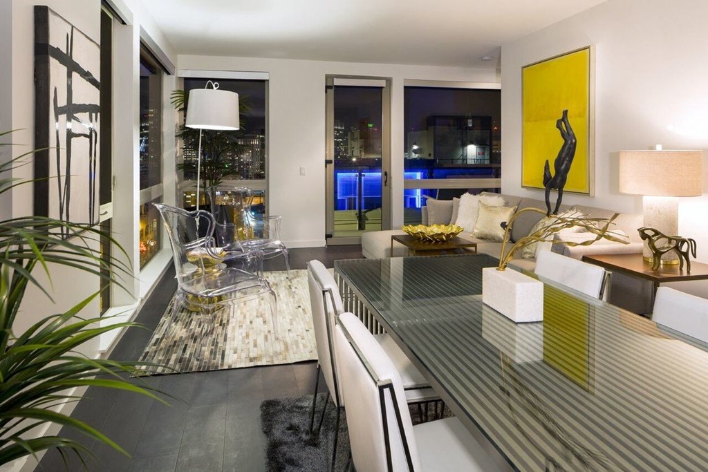 Apartment Dining and Living Room with City Skyline View Through Windows