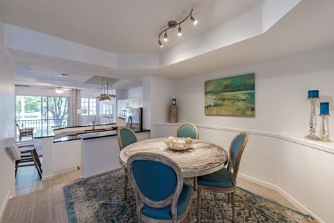 Dining area with a round table positioned beside the open kitchen.