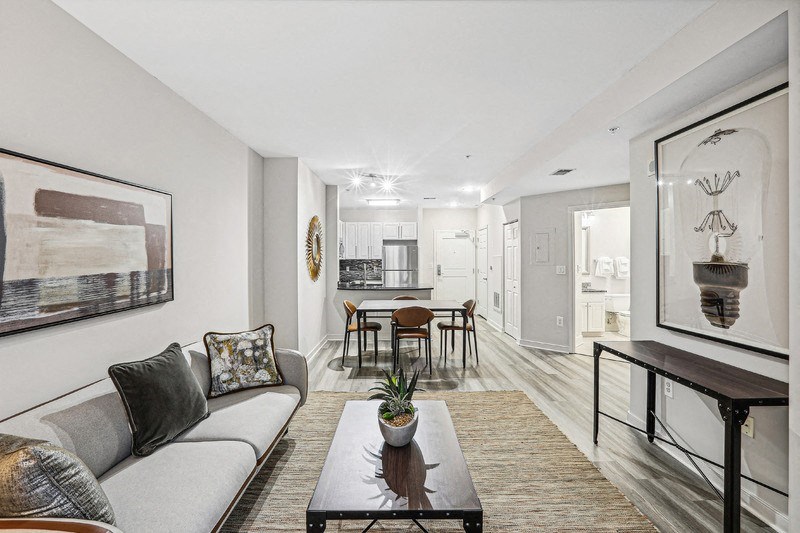 Full View of Living and Dining Area with Entrance to Bathroom