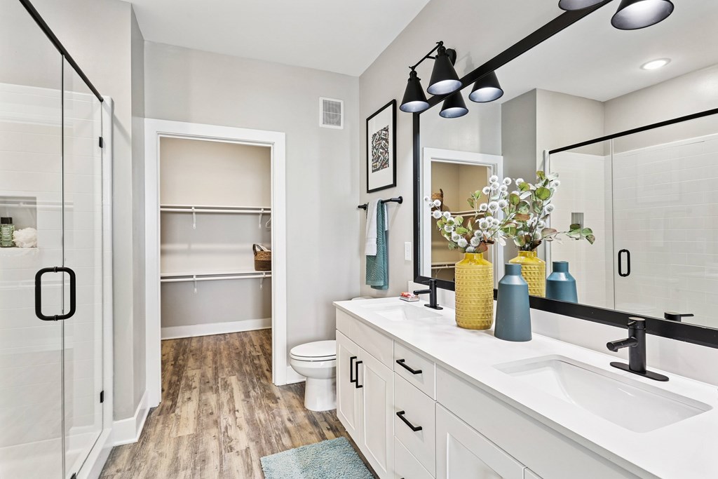 A bathroom with a white sink and a mirror.