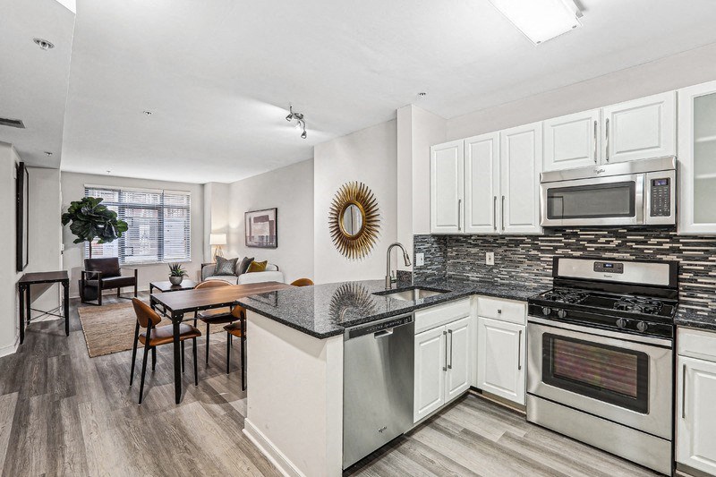 View from Kitchen Toward Bedroom, Dining Table, and Windowed Living Room