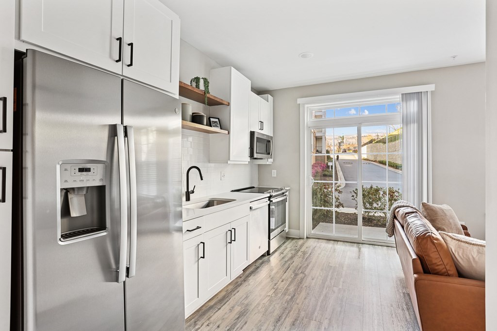 A modern kitchen with stainless steel appliances and white cabinets.
