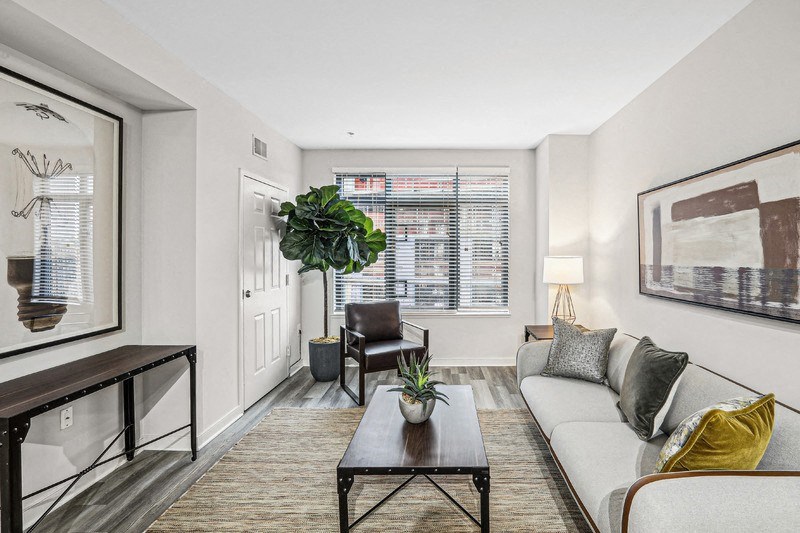Apartment Living Space Featuring Seating, Artwork, and Console Table