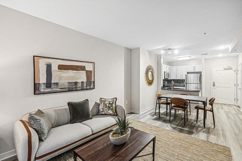 Apartment Living Room with Wall Art, Coffee Table, and View to Kitchen
