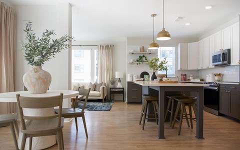 a kitchen and dining area with a table and chairs