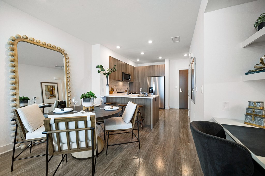 Dining nook with oversized mirror and cozy seating flowing seamlessly into the kitchen