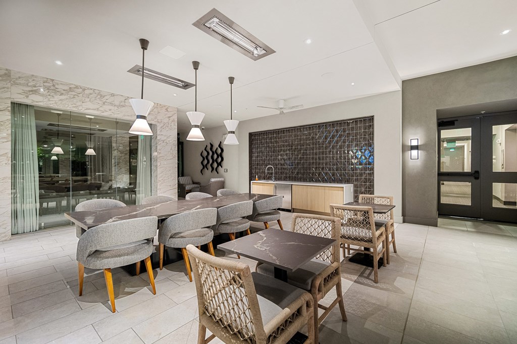 Elegant indoor lounge with marble accents, designer lighting, and flexible seating for dining or entertaining