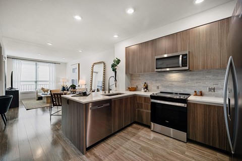 A modern kitchen with wooden cabinets and stainless steel appliances.