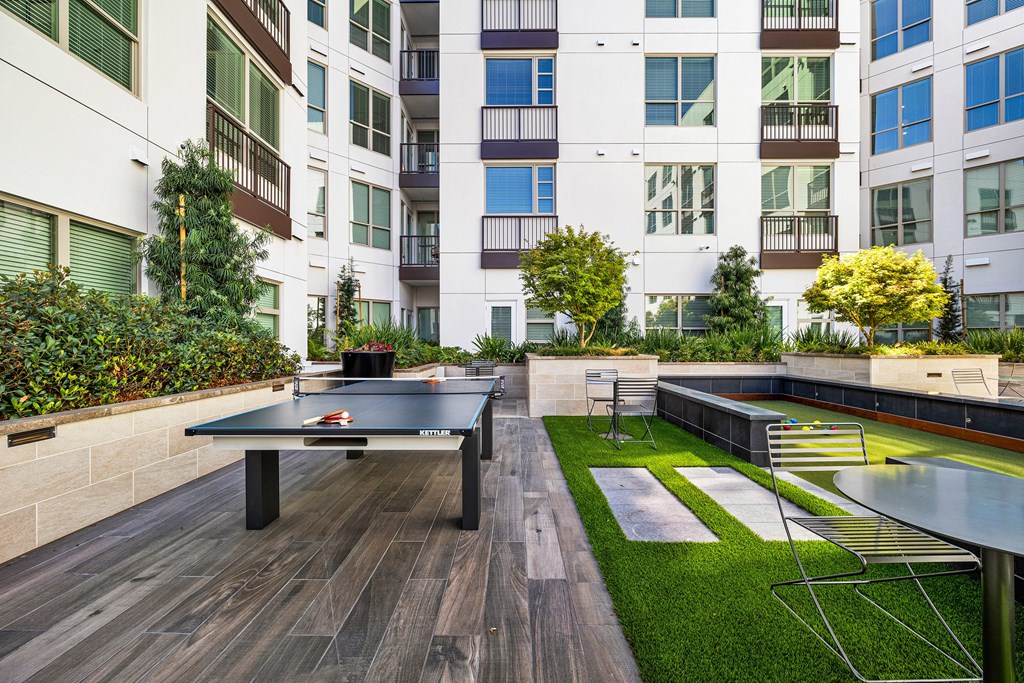 Outdoor courtyard with ping pong and bocce, offering playful spaces to connect with friends and neighbors