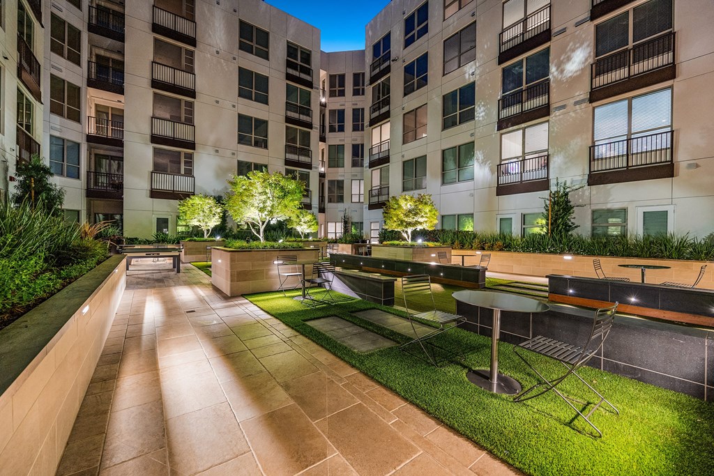 Tranquil courtyard with landscaped greenery, intimate seating, and modern design for outdoor gatherings