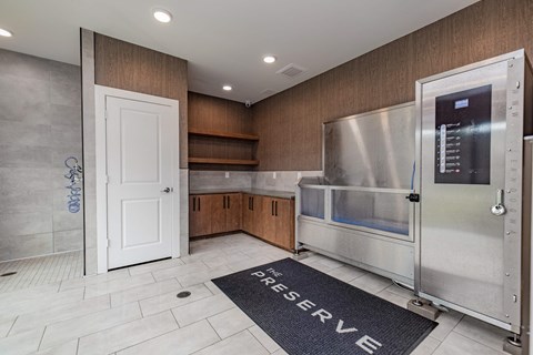 A kitchen with a large refrigerator and a mat on the floor that says "Reserve".