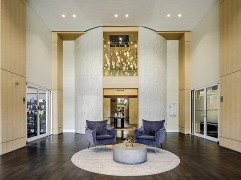 A modern living room with a circular grey coffee table in the middle.