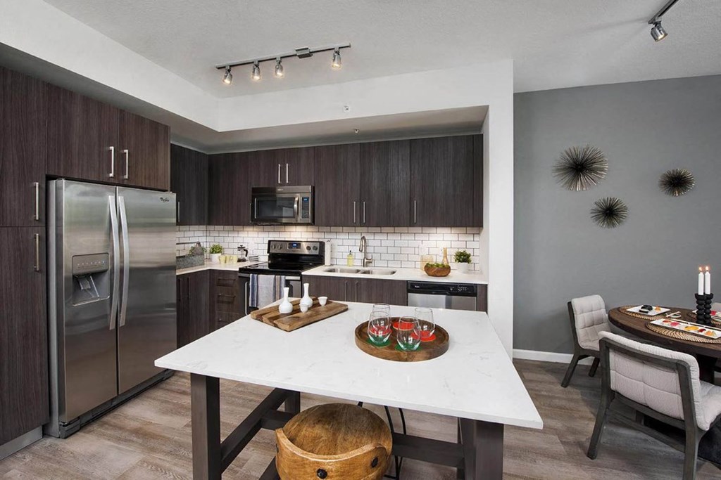 a kitchen with stainless steel appliances and a white counter top