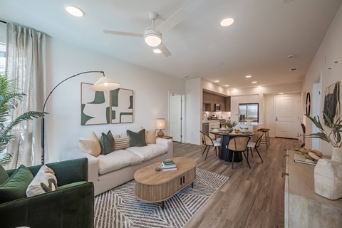 A modern living room with a green couch and a wooden coffee table.