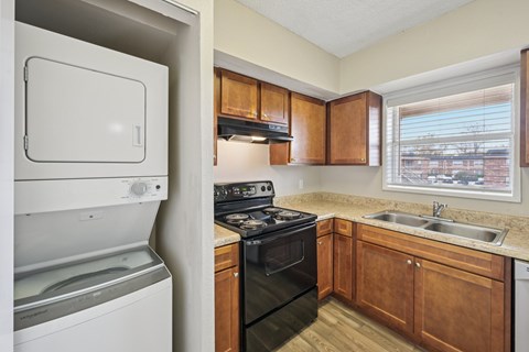 A small kitchen with a black stove top oven and a white dishwasher.