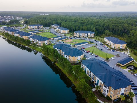 An aerial view of apartment buildings by a body of water.