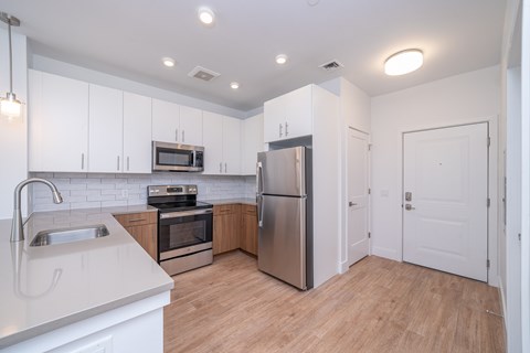 A kitchen with white cabinets and stainless steel appliances.