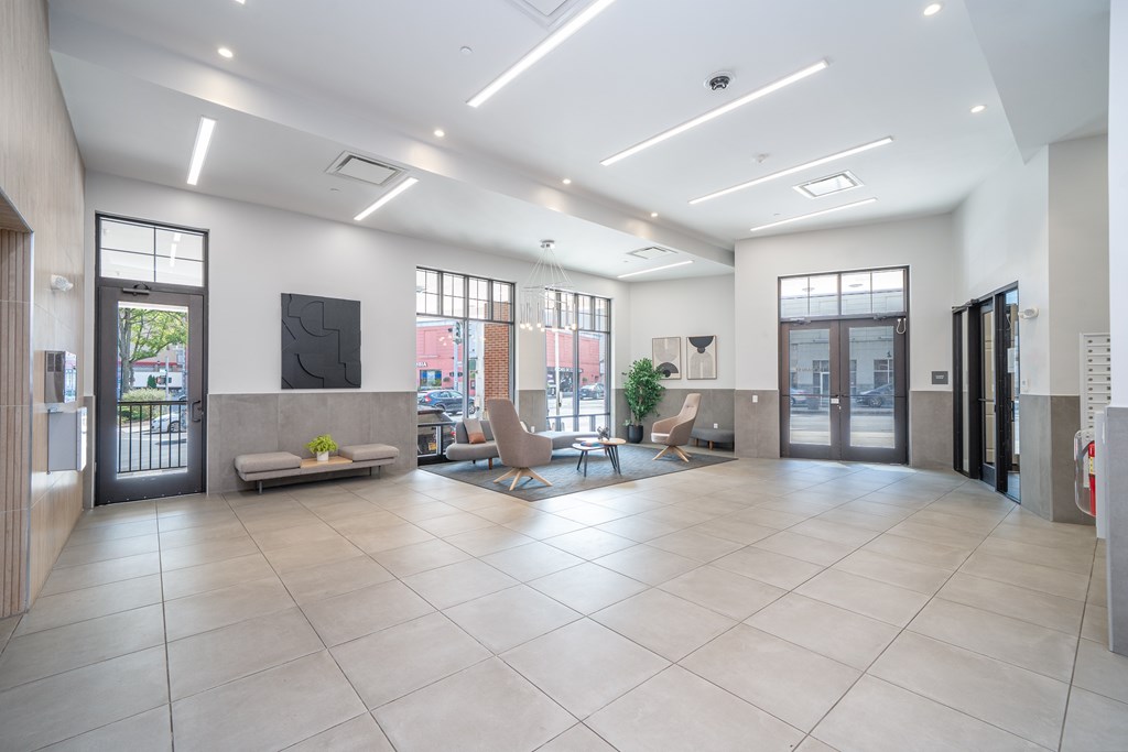 A spacious lobby with a flat screen TV and comfortable seating.