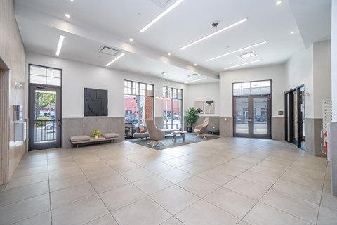 A spacious lobby with a flat screen TV and comfortable seating.