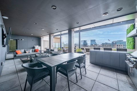 Rooftop dining area with covered patio and grill at 66 Summer Street Apartments, Stamford, CT 06901