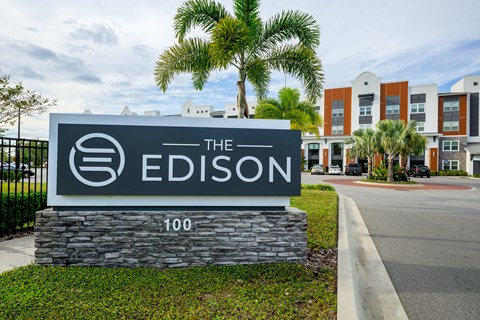 The Edison sign is in front of a building with palm trees.