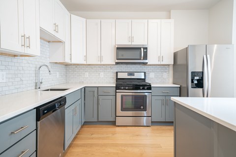 A kitchen with a stainless steel refrigerator and oven.