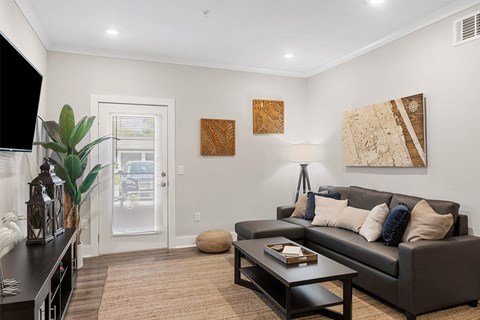 A living room with a brown couch and a coffee table.