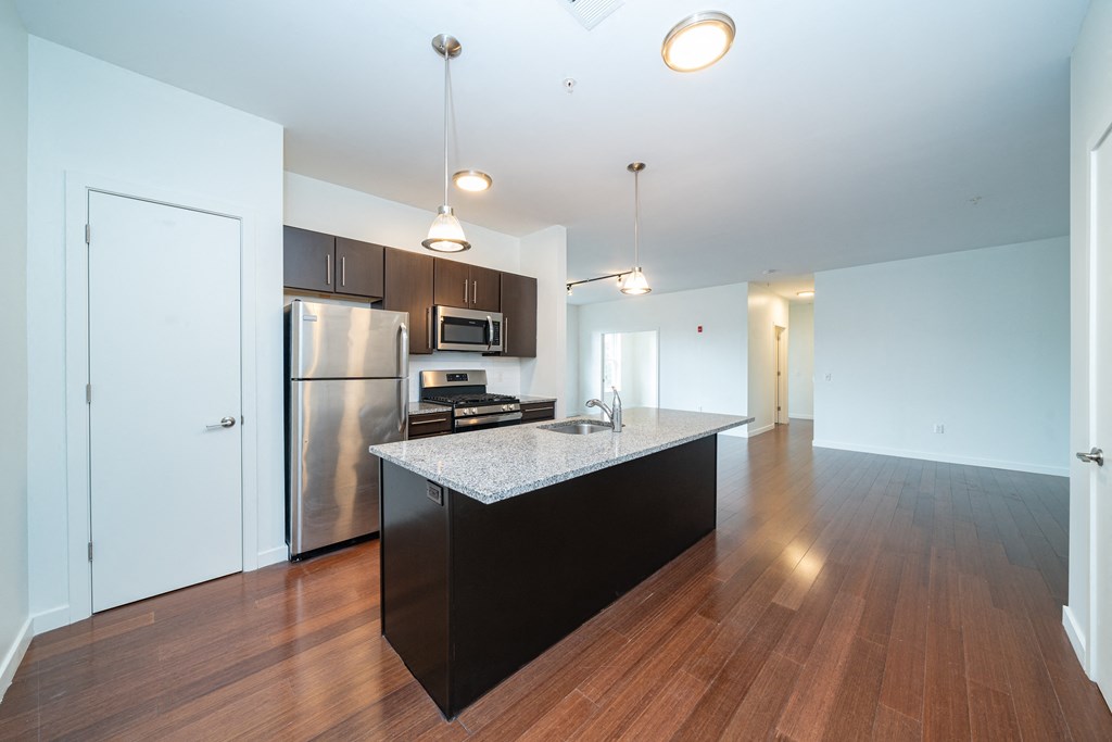a kitchen with stainless steel appliances and a granite counter top