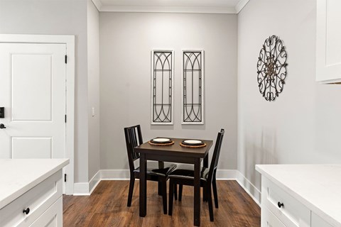 A dining room with a table set for two.