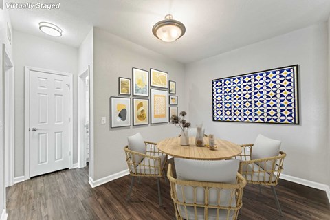 A dining room with a round table and chairs.