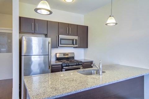 a kitchen with stainless steel appliances and a granite counter top