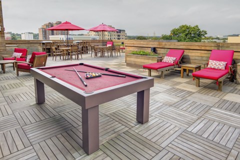 Rooftop deck with billiard table and lounge seating at 750 Summer Street Apartments, Stamford, CT 06901