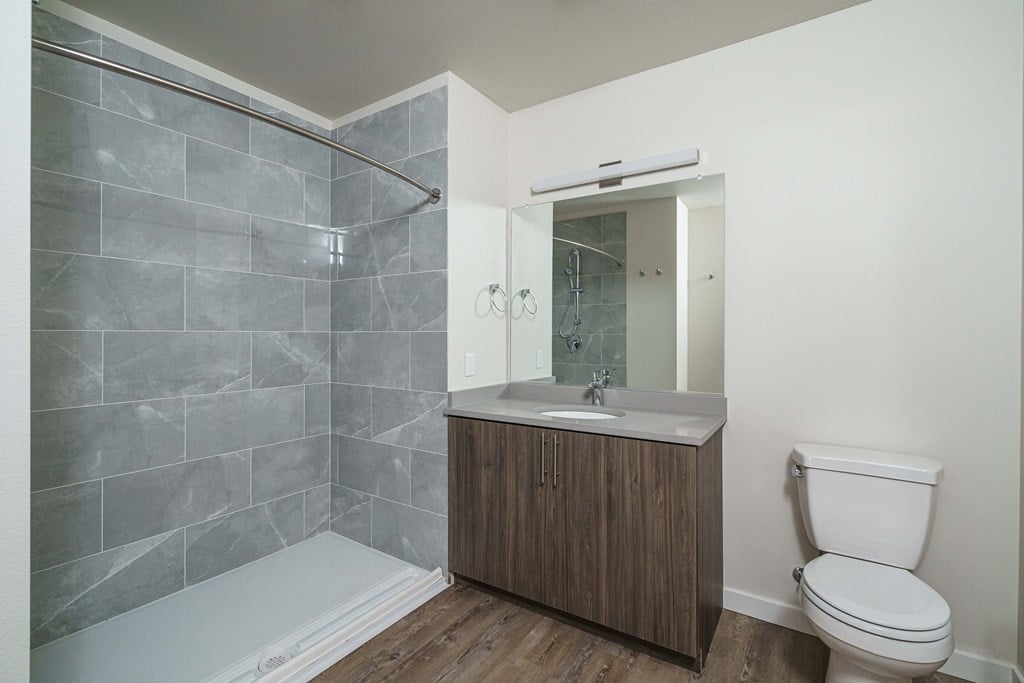 a bathroom with a toilet and a sink and a shower