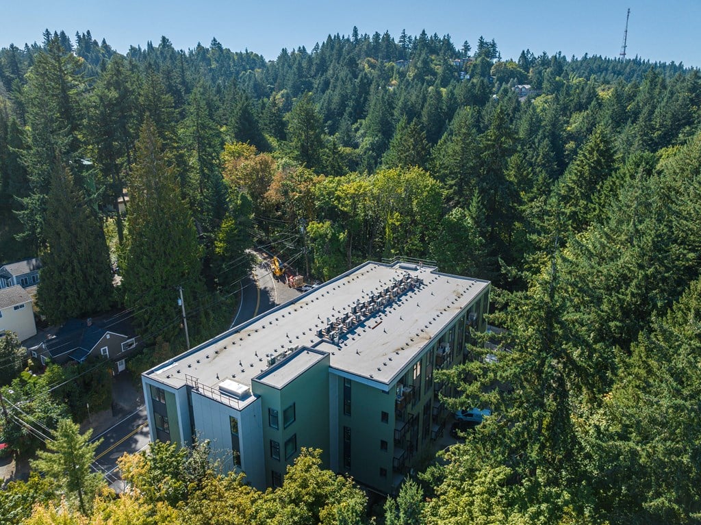 an aerial view of a building with a roof covered in solar panels