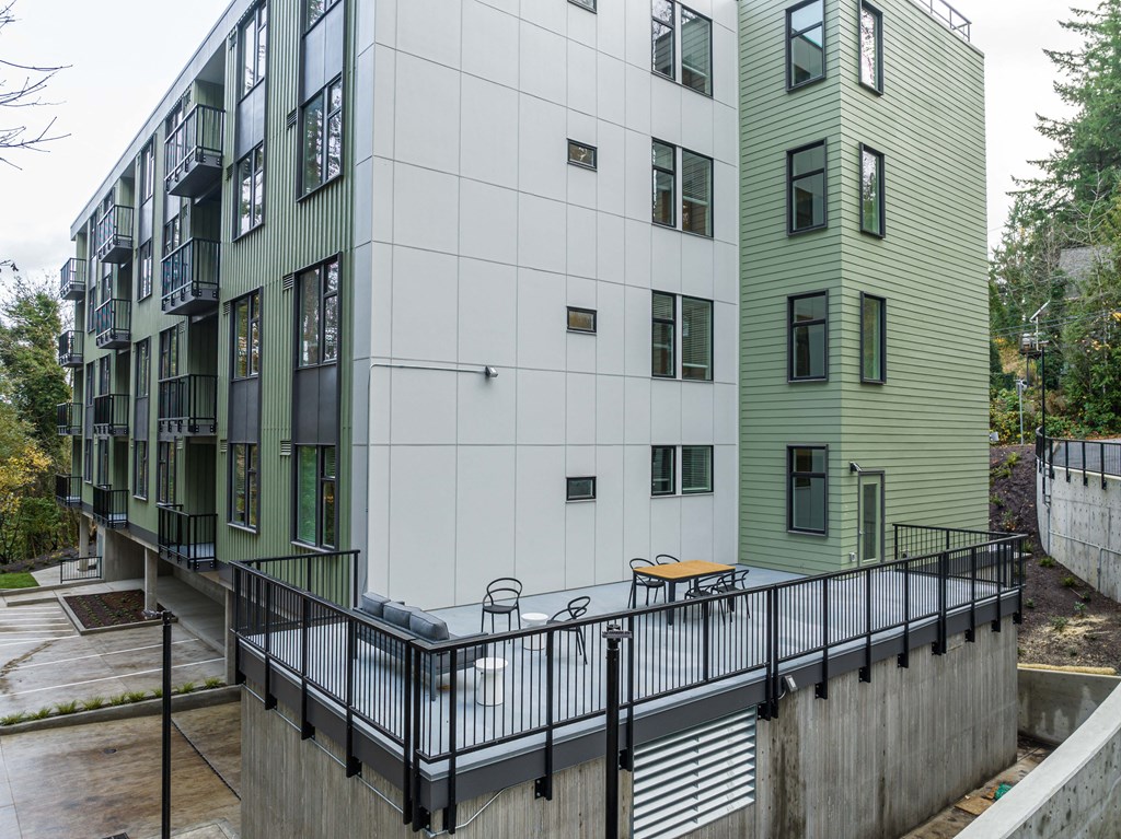 a white and green building with a ramp in front of it