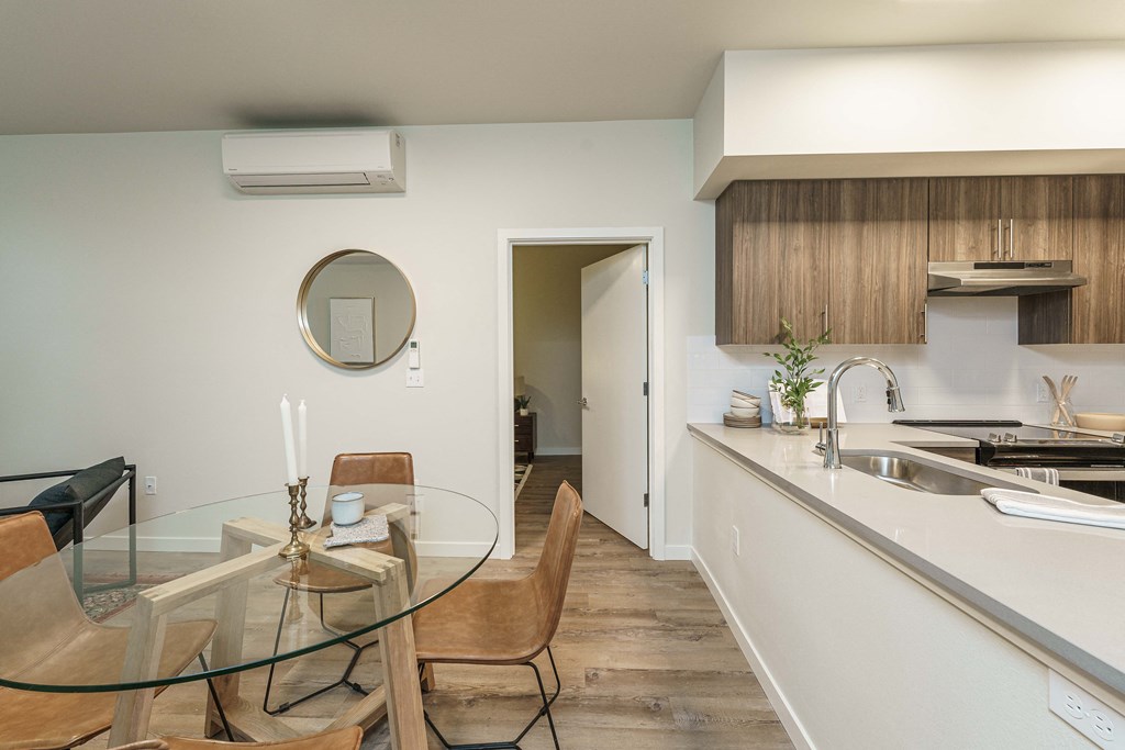 a kitchen and dining room with a glass table