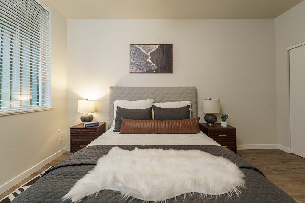 a bedroom with a large bed and a window